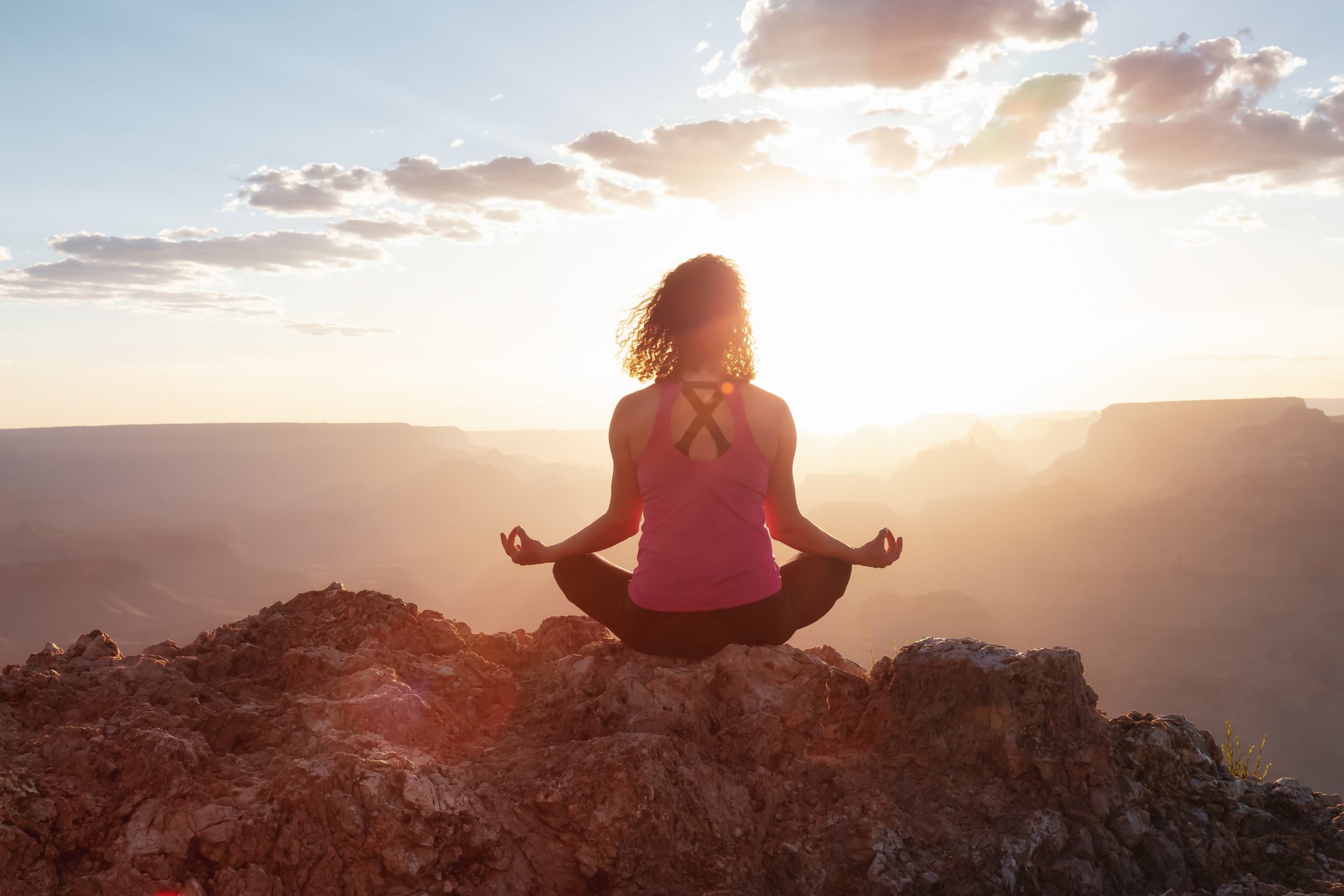 Adventurous,Traveler,Woman,Doing,Meditation,On,Desert,Rocky,Mountain,American